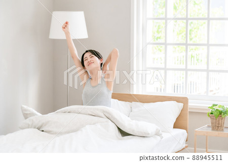 Morning awakening woman bed 88945511