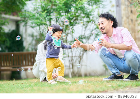 Parents interacting with a 1 year and 10 month old boy 88946358