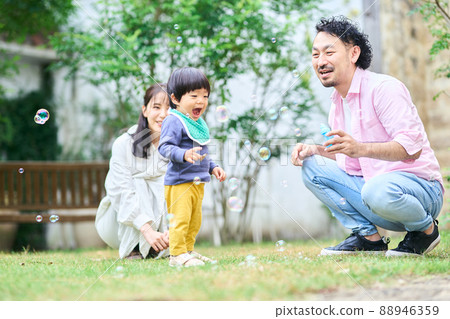 Parents interacting with a 1 year and 10 month old boy 88946359