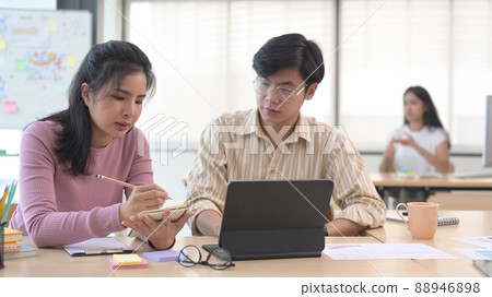 Team of creative people collaborating on their new project at modern office. 88946898