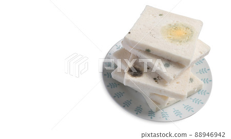 Close up view mold growing rapidly on expired bread isolated on white background. Close up view mold growing rapidly on expired bread isolated on white background. 88946942