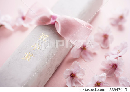 Diploma and cherry blossom petals Diploma and cherry blossom petals 88947445