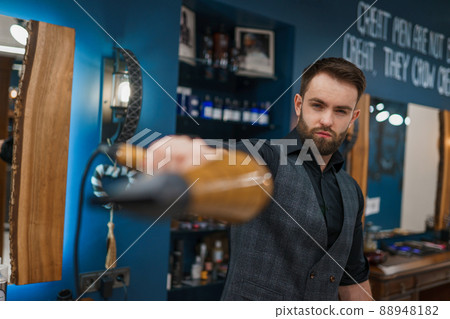 Stylish barber with hair dryer in hands Stylish barber with hair dryer in hands 88948182