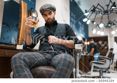 Barber master with a glass of whiskey Barber master with a glass of whiskey 88948184