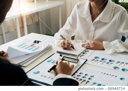 Financial adviser working with client, calculating and analyzing data paperwork chart for meeting team in office room. concept finance and accounting Financial adviser working with client, calculating and analyzing data paperwork chart for meeting team in office room. concept finance and accounting 88948714