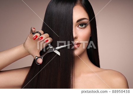 A young woman cutting her hair 88950438