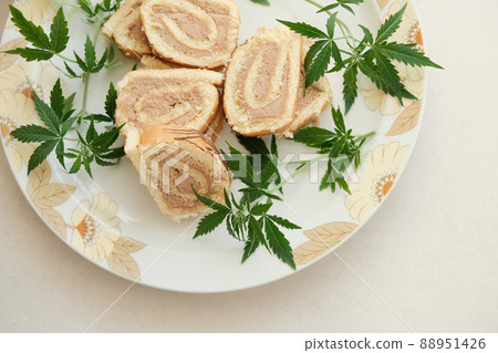 Sweet roll with marijuana oil on white plate. Cannabis kitchen 88951426