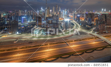 Panoramic skyline of Dubai with business bay and downtown district night to day timelapse. 88951651