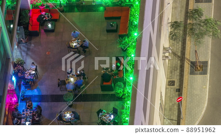 Outdoor terrace with tables and chairs in restaurant aerial top view night timelapse Outdoor terrace with tables and chairs in restaurant aerial top view night timelapse 88951962