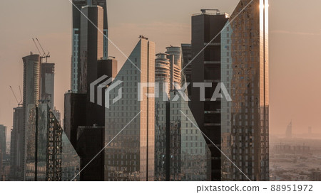 Sun reflected from office towers glass surface in financial district of Dubai city timelapse. Sun reflected from office towers glass surface in financial district of Dubai city timelapse. 88951972
