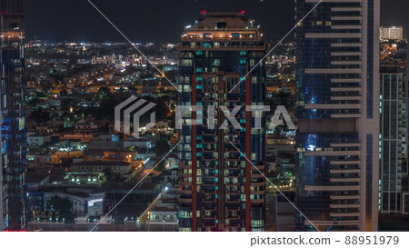 Glowing windows and towers and villa houses on a background aerial night timelapse, Dubai, United Arab Emirates Glowing windows and towers and villa houses on a background aerial night timelapse, Dubai, United Arab Emirates 88951979