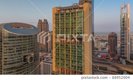 Dubai international financial center skyscrapers with long shadows aerial morning timelapse. 88952004