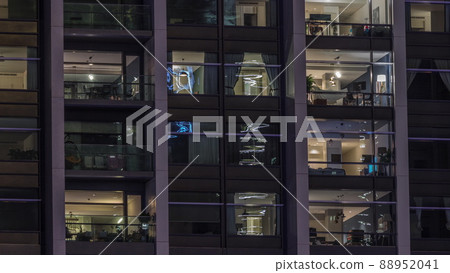 Big glowing windows in modern office and residential buildings timelapse at night Big glowing windows in modern office and residential buildings timelapse at night 88952041