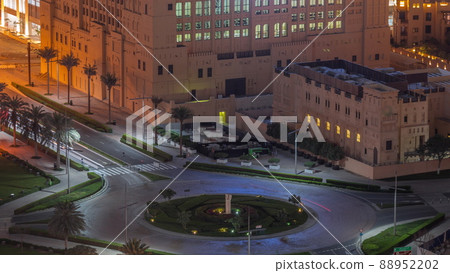 Aerial view of a roundabout circle road intersection in Dubai downtown from above night timelapse. 88952202