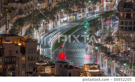 Intersection traffic night timelapse on Mohammed Bin Rashid Boulevard curves among the many illuminated skyscrapers and towers 88952205