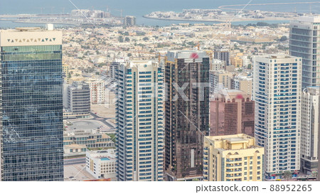 Aerial view of apartment houses and villas behind skyscrapers in Dubai city timelapse, United Arab Emirates 88952265
