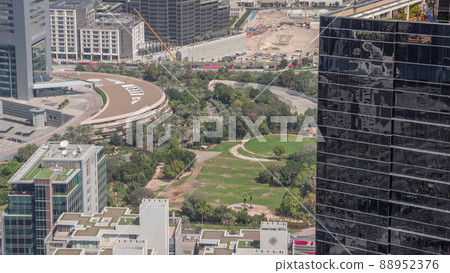 Park in financial district with large construction site with excatation including excavators and cranes timelapse Park in financial district with large construction site with excatation including excavators and cranes timelapse 88952376