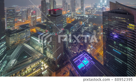 Panorama of futuristic skyscrapers in financial district business center in Dubai night to day timelapse Panorama of futuristic skyscrapers in financial district business center in Dubai night to day timelapse 88952395