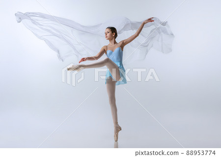 Beautiful young girl, aspiring ballerina in blue dress and pointes dancing with cloth isolated on gray background. Art, grace, beauty, ballet school concept Beautiful young girl, aspiring ballerina in blue dress and pointes dancing with cloth isolated on gray background. Art, grace, beauty, ballet school concept 88953774