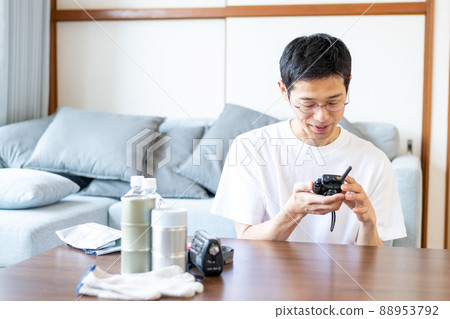 A man participating in a communication training using a transceiver prepared in a disaster prevention drill of a local government 88953792
