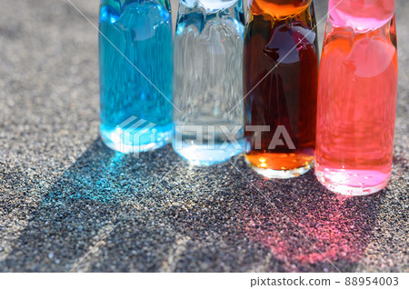Bottled juice lined up on the beach Retro Sea Bottled juice lined up on the beach Retro Sea 88954003