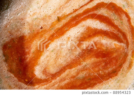 Tomato juice close-up. On the surface bubbles of different sizes and foam. Fresh natural product for the preparation of sauces. Tomato juice close-up. On the surface bubbles of different sizes and foam. Fresh natural product for the preparation of sauces. 88954323