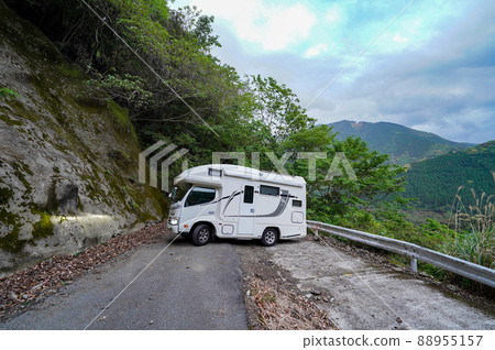 A camper on the verge of distress after getting lost in a mountain road A camper on the verge of distress after getting lost in a mountain road 88955157