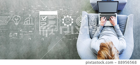 Project management theme with man using a laptop Project management theme with man using a laptop 88956568