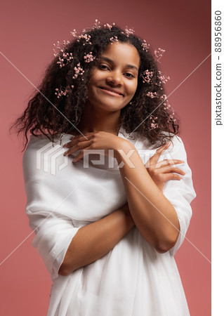 Portrait of young tender woman in white bathrobe posing, smiling at camera isolated over pink studio background Portrait of young tender woman in white bathrobe posing, smiling at camera isolated over pink studio background 88956860