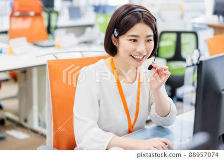 Young woman working in a call center 88957074