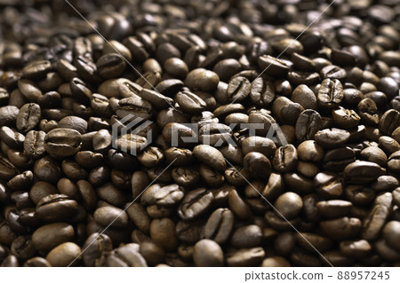 Pile of roasted coffee beans. Freshly roasted strong aromatic coffee beans in a large pile. Pile of roasted coffee beans. Freshly roasted strong aromatic coffee beans in a large pile. 88957245