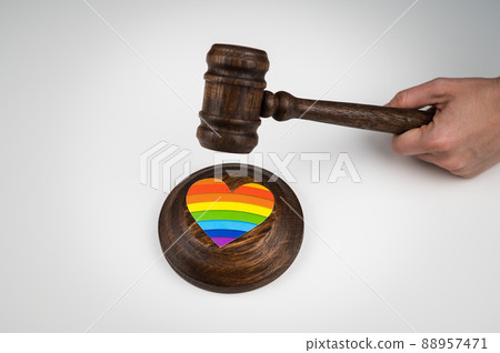 The judge hits a heart with a rainbow flag with a gavel. 88957471