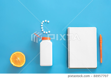 Flat lay, pills on blue background, vitamin c concept. Flat lay, pills on blue background, vitamin c concept. 88957707
