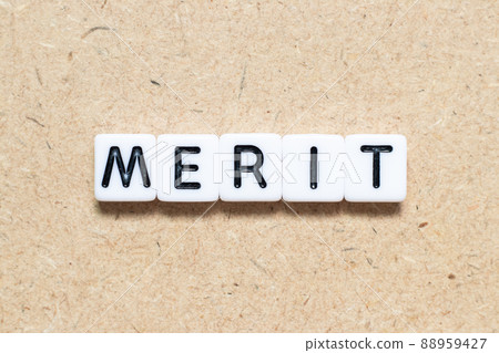 White tile alphabet letter with word merit on wood background White tile alphabet letter with word merit on wood background 88959427