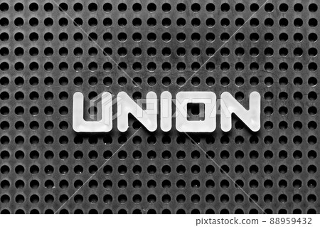 White alphabet letter in word union on black pegboard background 88959432