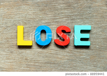Color alphabet letter in word lose on wood background Color alphabet letter in word lose on wood background 88959441