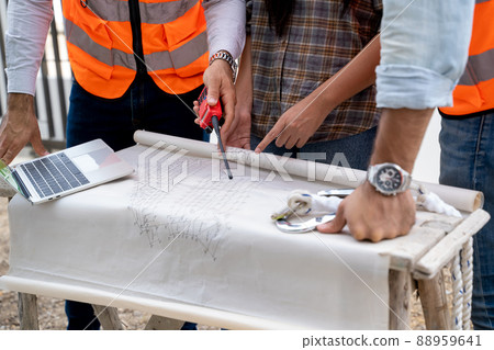 Architect and engineer meeting planning for a new project about detail of building. Architect and engineer meeting planning for a new project about detail of building. 88959641