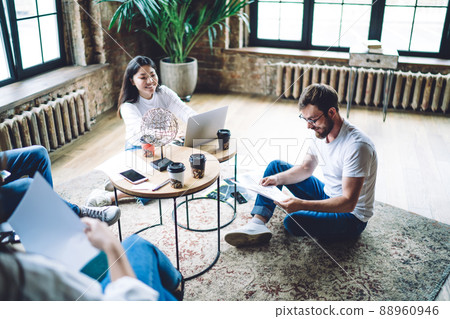 Happy diverse coworkers discussing project on coffee break Happy diverse coworkers discussing project on coffee break 88960946