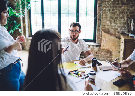 Diverse friends creating presentation during work in office Diverse friends creating presentation during work in office 88960986