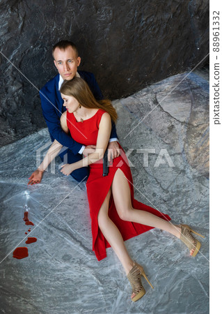 young guy sits on floor and hugs girl young guy sits on floor and hugs girl 88961332