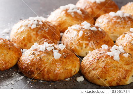 Delicious crispy hot bath bun with cumin and sugar close-up. Horizontal Delicious crispy hot bath bun with cumin and sugar close-up. Horizontal 88961724