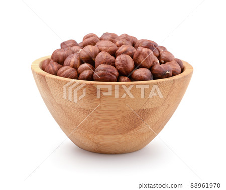 Hazelnuts in a wooden bowl isolated. Hazelnuts in a wooden bowl isolated. 88961970
