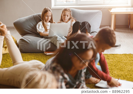 Children using laptop while sitting in classroom Children using laptop while sitting in classroom 88962295