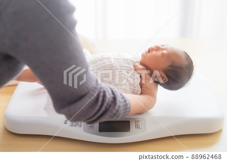 Newborn baby weighing 9 days after birth 88962468