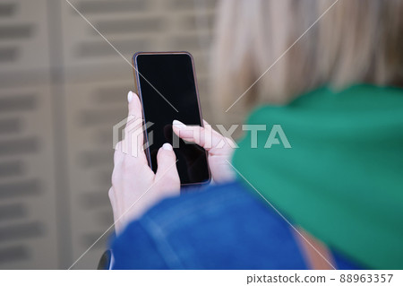 Woman typing text message using mobile phone closeup 88963357