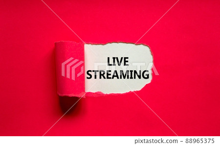 Live streaming symbol. Concept words Live streaming appearing behind torn pink paper. Beautiful pink background. Business, live streaming concept, copy space. Live streaming symbol. Concept words Live streaming appearing behind torn pink paper. Beautiful pink background. Business, live streaming concept, copy space. 88965375