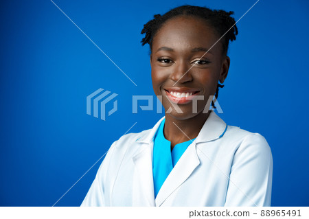 Portrait of young african female doctor in blue studio 88965491