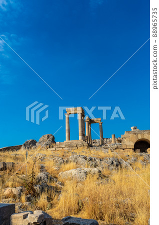 Ancient stone pillars of acropolis Lindos 88965735