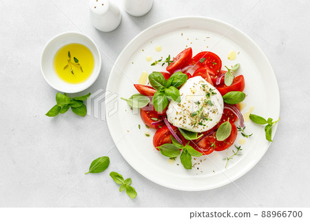 Salad Caprese with tomato, mozzarella and basil, italian food Salad Caprese with tomato, mozzarella and basil, italian food 88966700