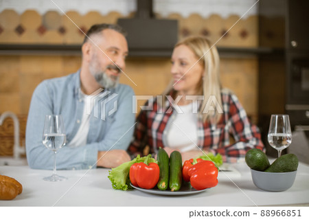 Mature family using healthy vegetables for cooking at home Mature family using healthy vegetables for cooking at home 88966851